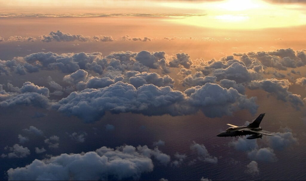 HD Wallpaper: Jet in Serene Sky at Sunset with Soft Clouds Background