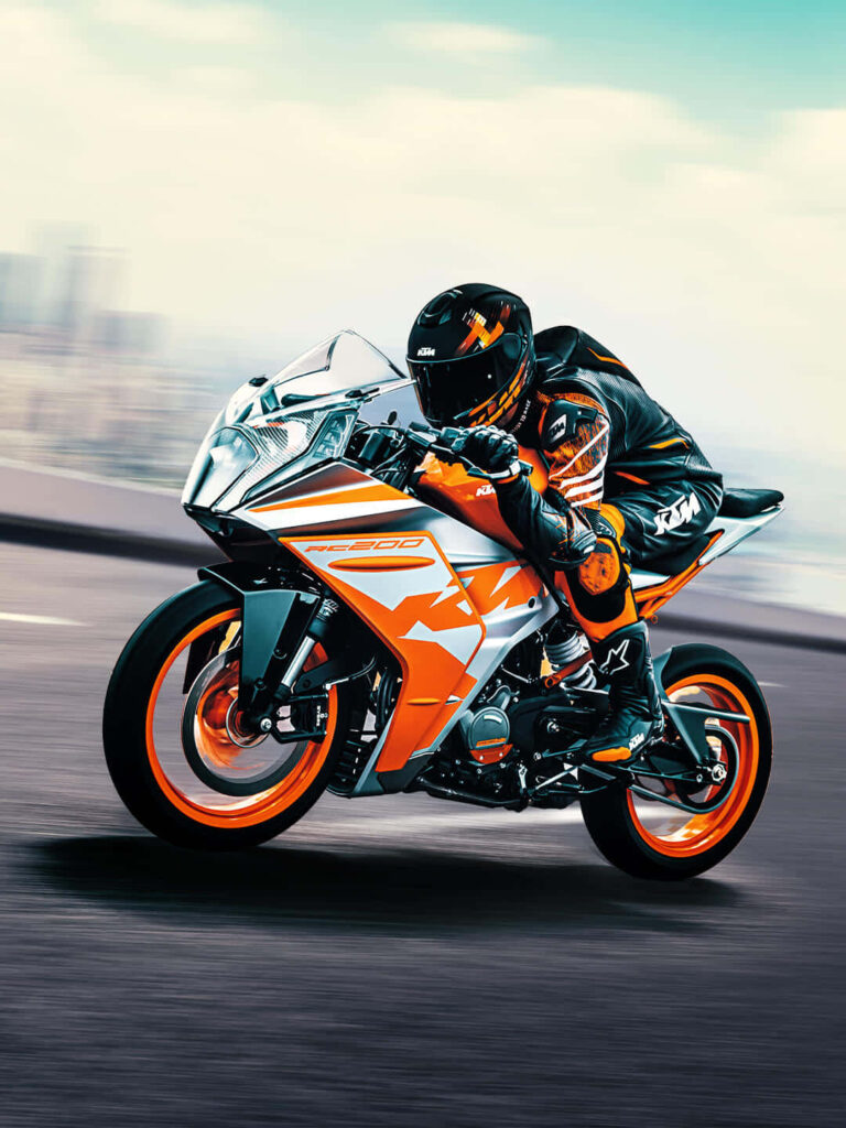 KTM Motorcycle Racing: Stunning High-Speed Wallpaper with Vibrant Design