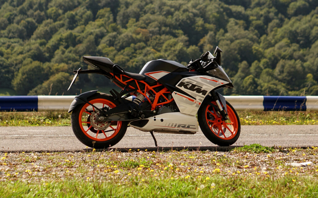 Sleek KTM RC Motorcycle in Scenic Greenery - Vibrant Wallpaper