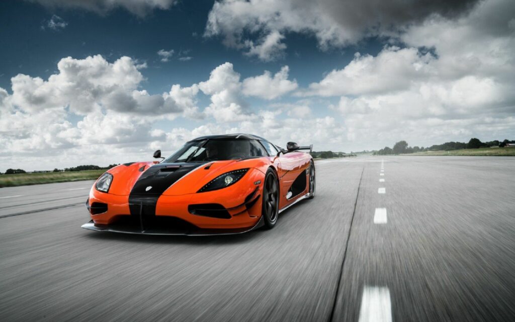 Stunning Koenigsegg Agera Wallpaper: Dynamic Front View on Open Road