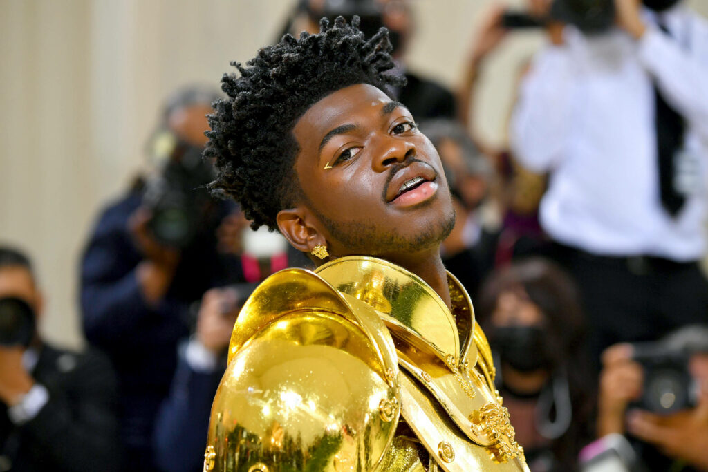 Bold Lil Nas X Wallpaper: Glamorous Gold Armor Style Background