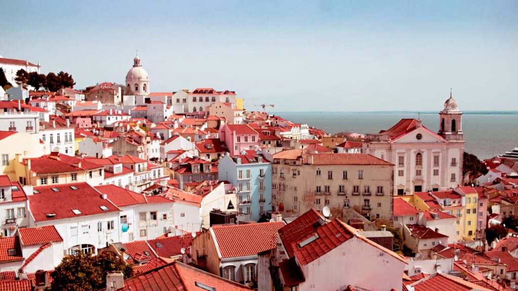 Vibrant Lisbon Coastline: Colorful Buildings & Ocean Wallpaper