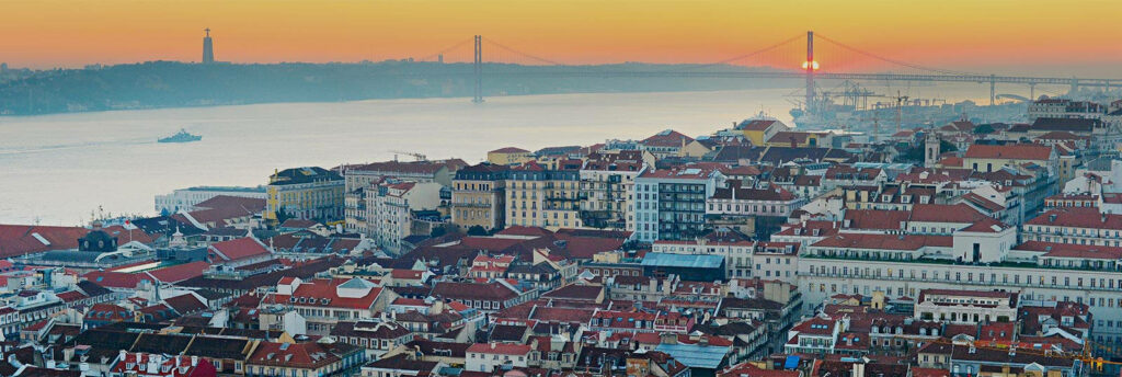 Stunning Lisbon Sunset: Panoramic Wallpaper with Rooftops & Bridge