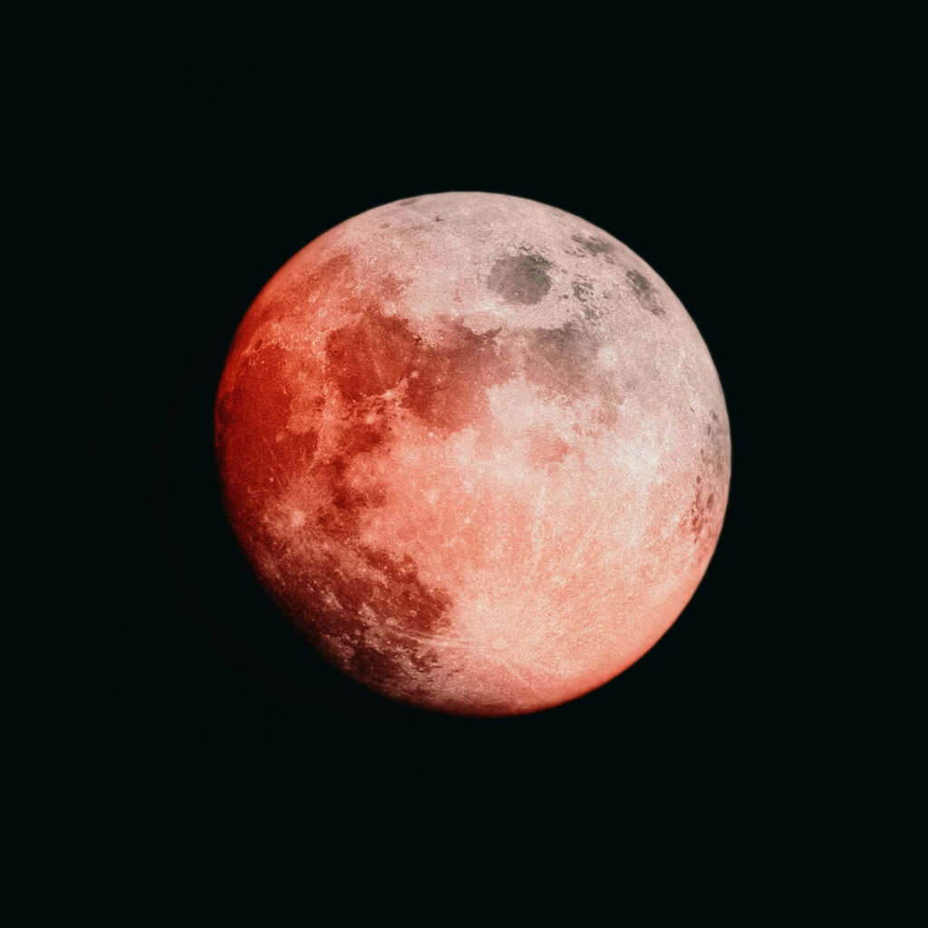 Lunar Eclipse Wallpaper: Reddish Moon on Dark Background