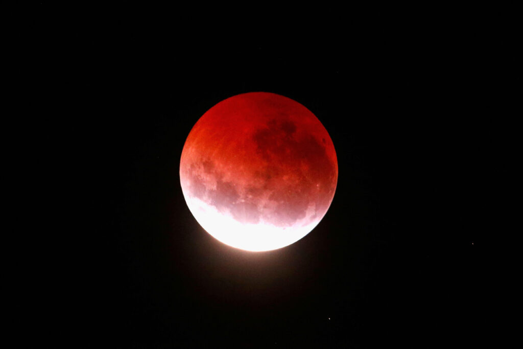 Vivid Lunar Eclipse Wallpaper: Red & Orange Moon in Space