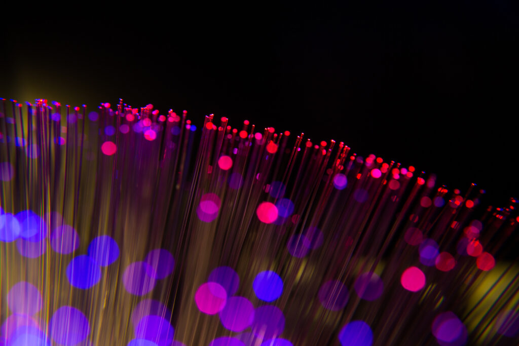 Stunning Macro Wallpaper: Glowing Optical Fibers in Pink & Blue Bokeh