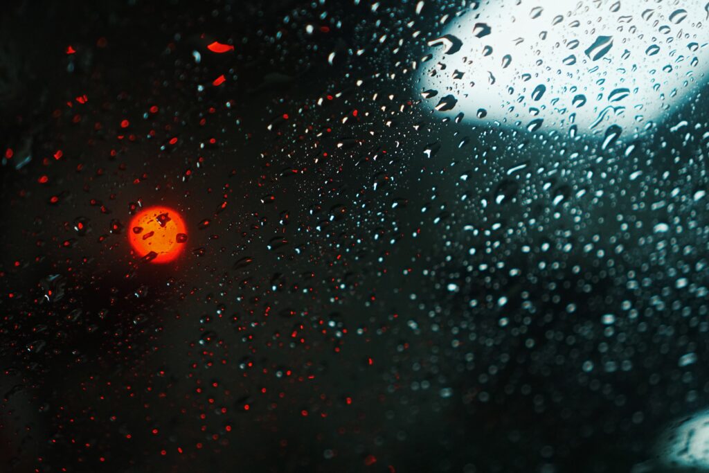 Macro Raindrops on Glass: Glowing Red Bokeh Wallpaper