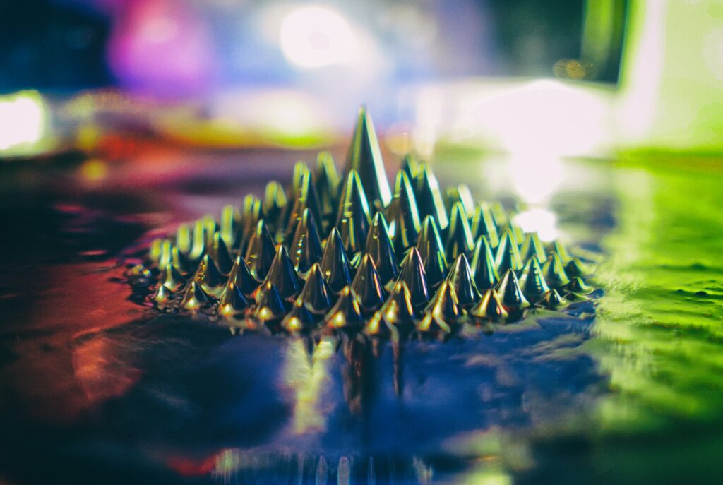 Vibrant Macro Metallic Spikes: Colorful Wet Wallpaper Background