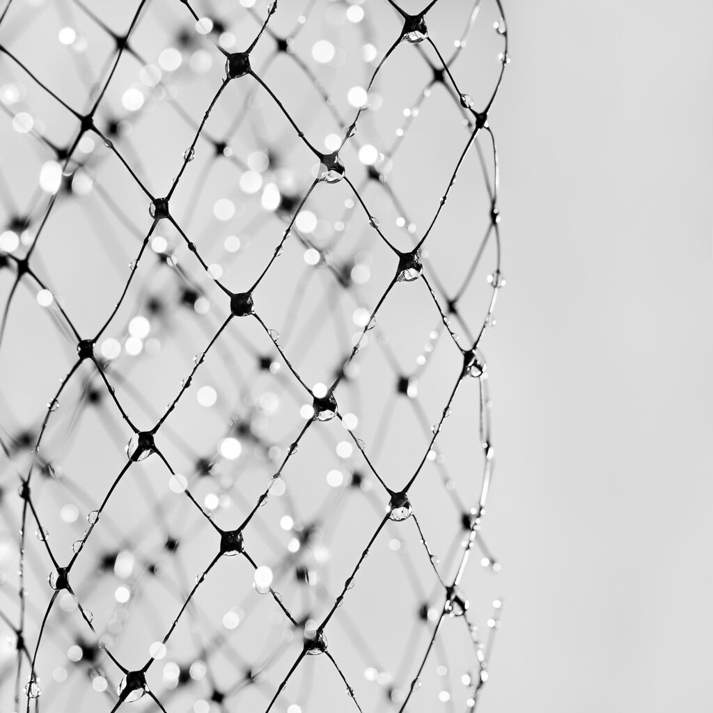 Stunning Macro Dew Drops on Mesh - Intricate Patterns Wallpaper