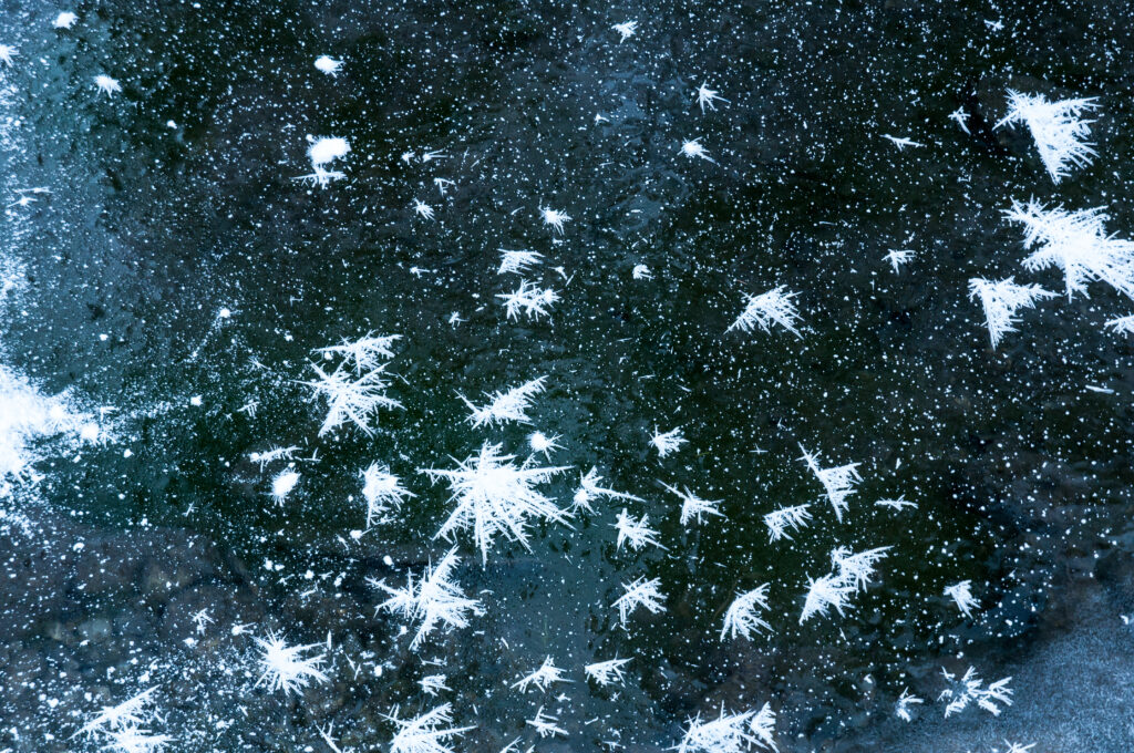 Stunning Macro Wallpaper of Snowflakes and Ice Crystals on Dark Surface