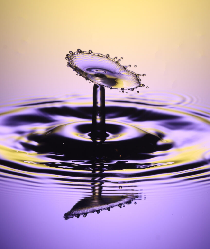 Stunning Macro Wallpaper: Liquid Droplet Splash in Yellow & Purple