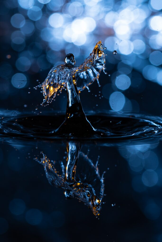 Stunning Macro Wallpaper: Water Droplet Elegance in Blue & Gold