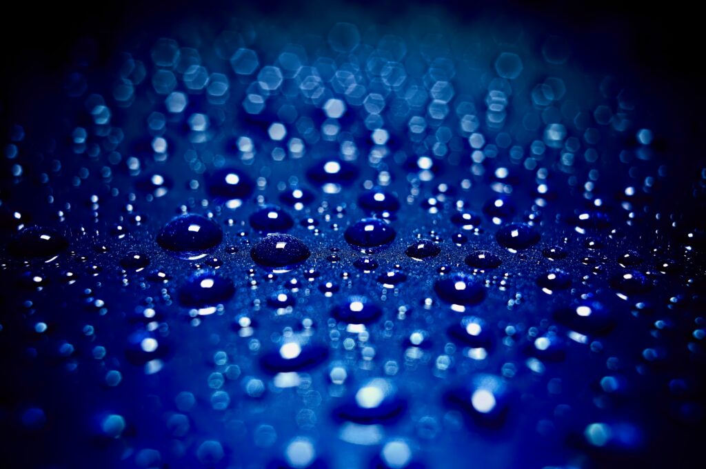 Stunning Macro Wallpaper: Water Drops on Blue Surface with Blur