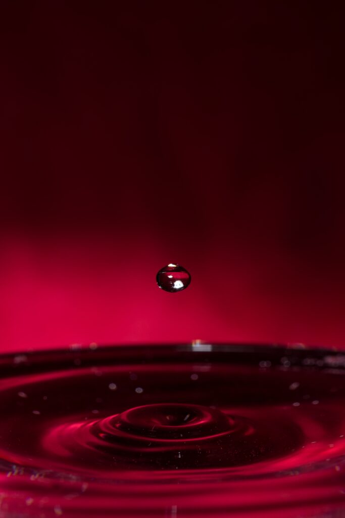 Stunning Macro Wallpaper: Water Droplet on Vibrant Red Background