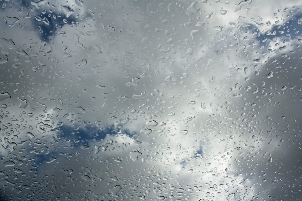 Textured Sky: Macro Water Droplets on Glass Wallpaper Background