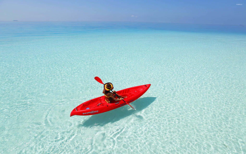 Turquoise Waters & Red Kayak: Tranquil Maldives Wallpaper