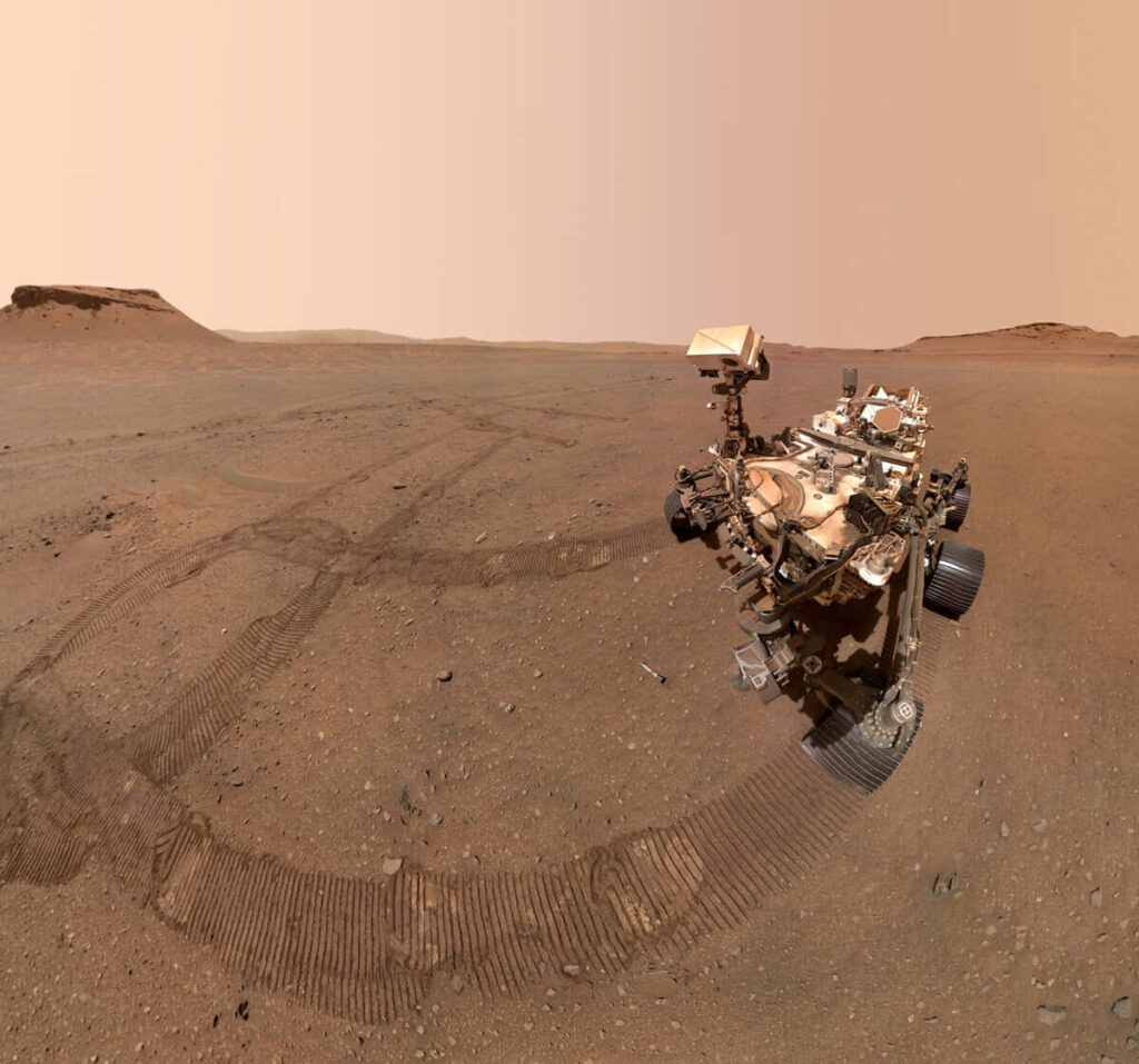 Stunning Mars Landscape: Rover Exploring Rocky, Reddish Terrain Wallpaper