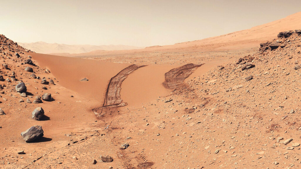 Martian Rocky Terrain Wallpaper: Rover Tracks & Orange Sky Background