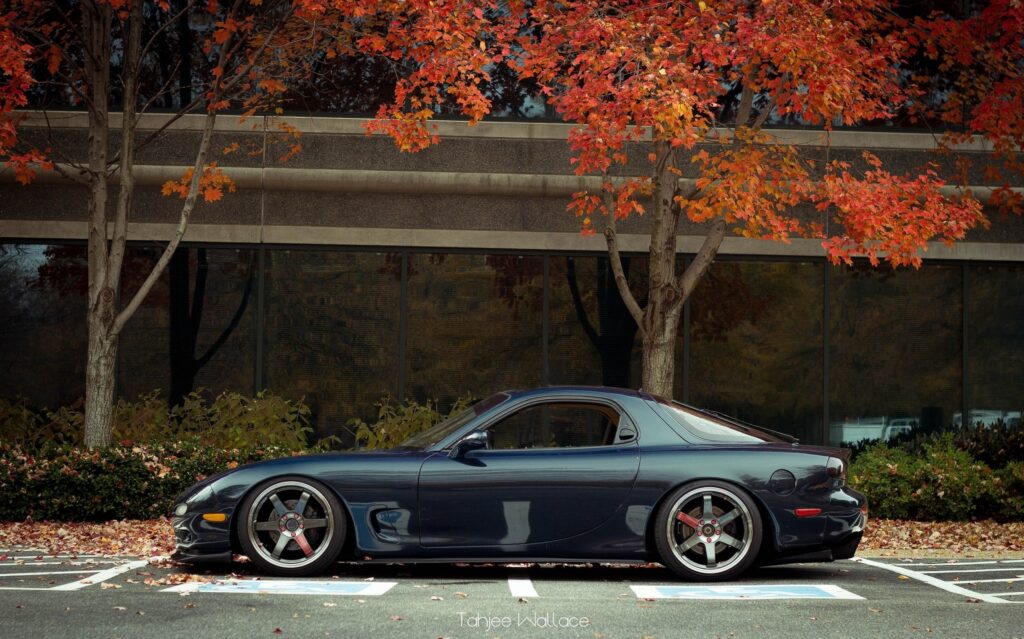 Sleek Mazda Sports Car Amidst Vibrant Autumn Foliage Wallpaper