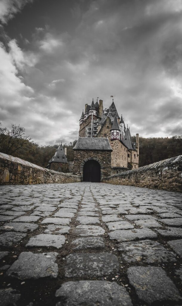 Stunning Medieval Castle Wallpaper with Dramatic Sky & Cobblestone Path