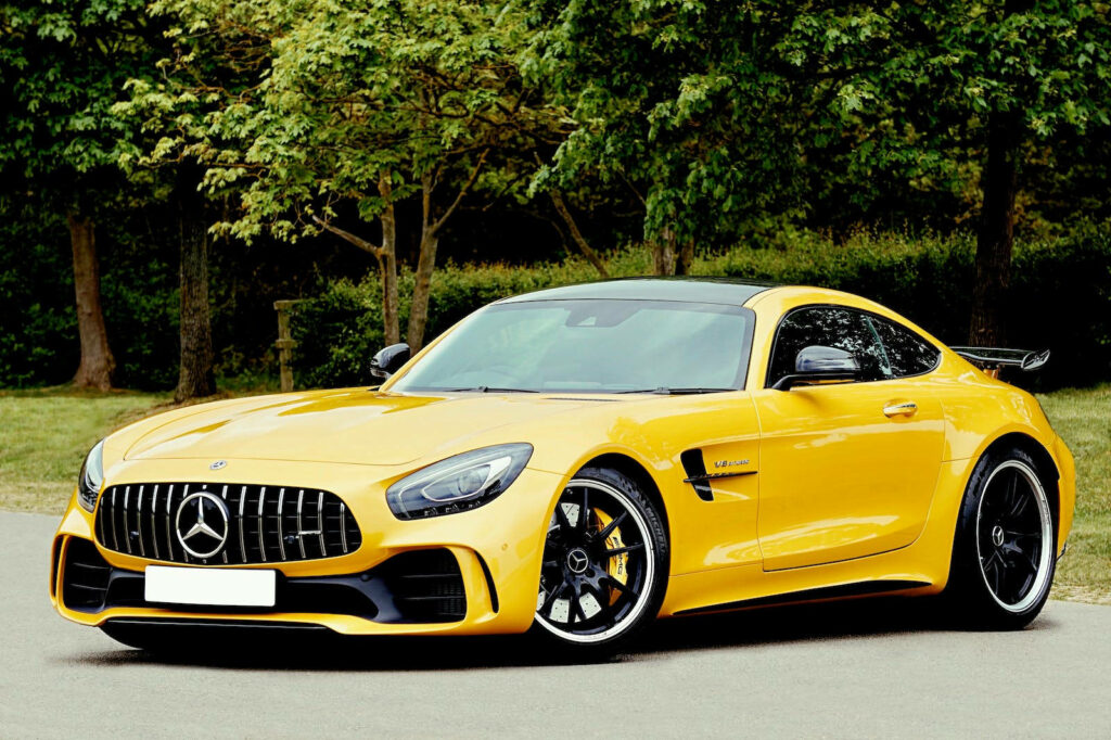 Stunning Yellow Mercedes-Benz AMG GT Wallpaper with Lush Green Backdrop