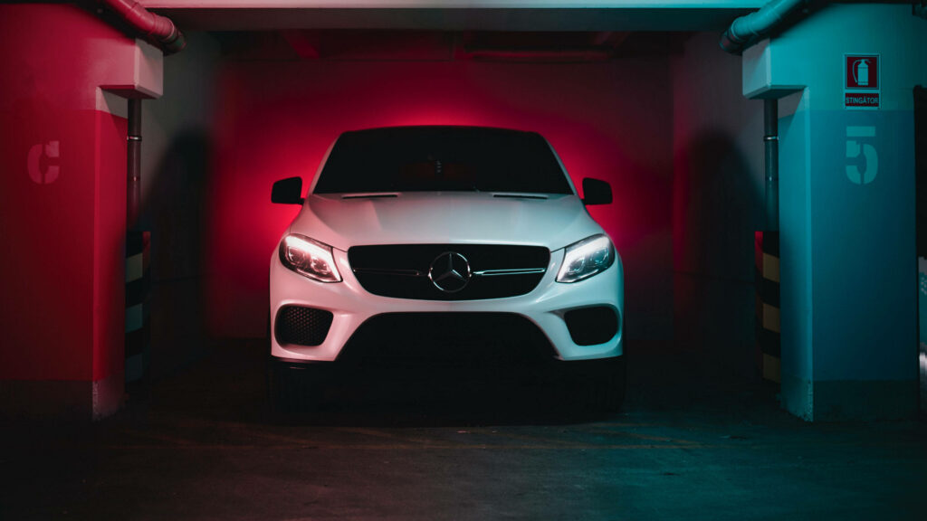 Luxurious White Mercedes-Benz GLE Wallpaper in Dramatic Garage Lighting
