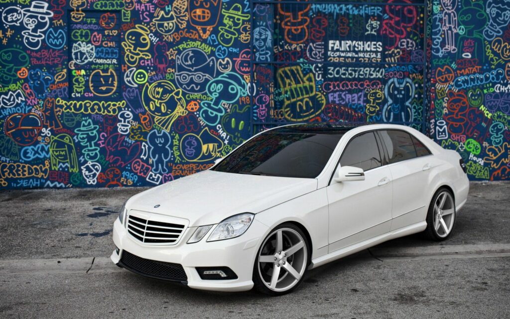 Sleek White Mercedes E-Class Wallpaper with Graffiti Background