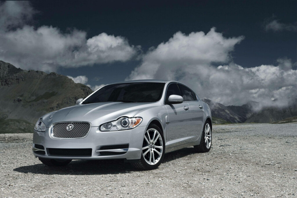 Luxury Metallic Grey Jaguar Car Wallpaper in Dramatic Mountains