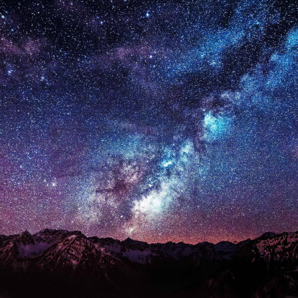 Breathtaking Milky Way galaxy over rugged mountains: starry night sky wallpaper.
