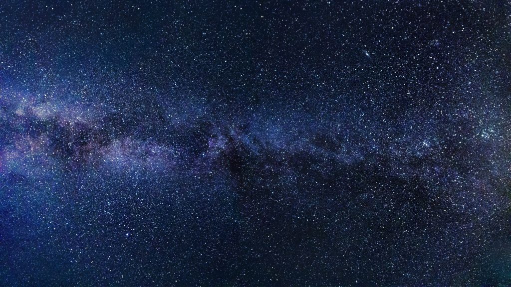 Stunning Milky Way wallpaper with dense starfields and deep blue indigo galactic dust background