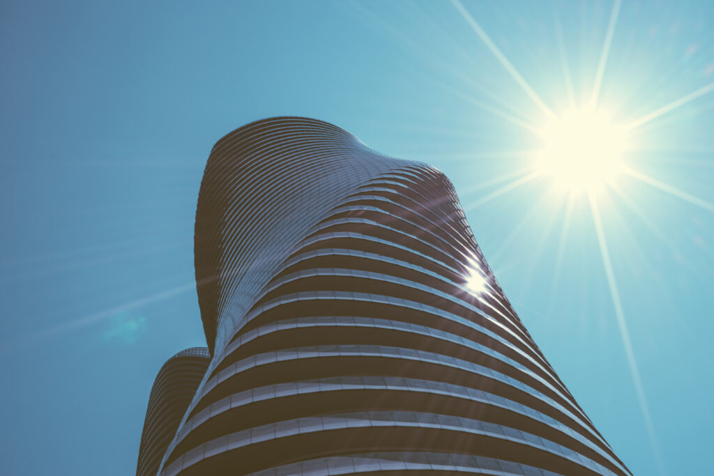 Stunning Curved Building Wallpaper Against Bright Blue Sky