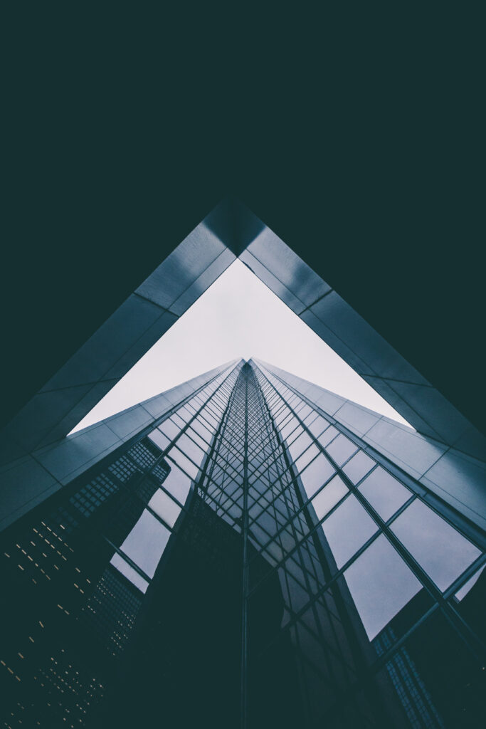 Modern Building Wallpaper: Sleek Glass Facade & Dramatic Angle