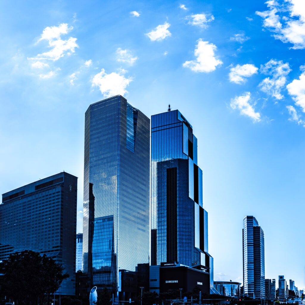Elegant Skyscraper Wallpaper: Modern Glass Facades & Blue Sky