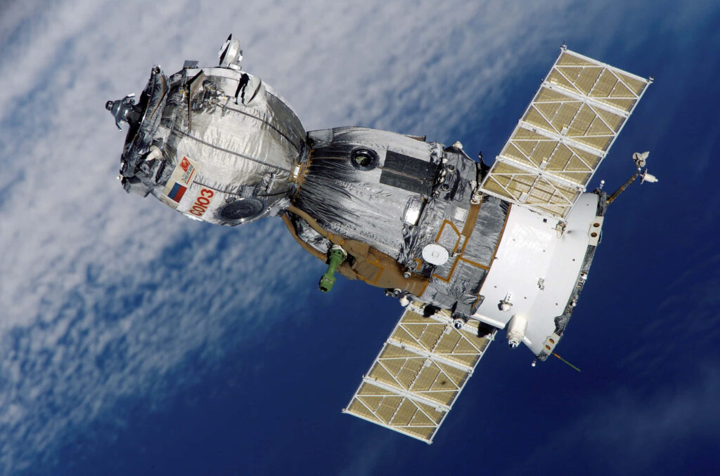 Modern Spacecraft Orbiting Earth: Intricate Design Wallpaper