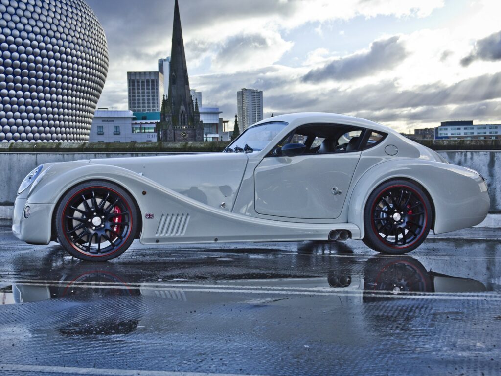 Elegant White Morgan Aero Coupe Wallpaper in Urban Setting