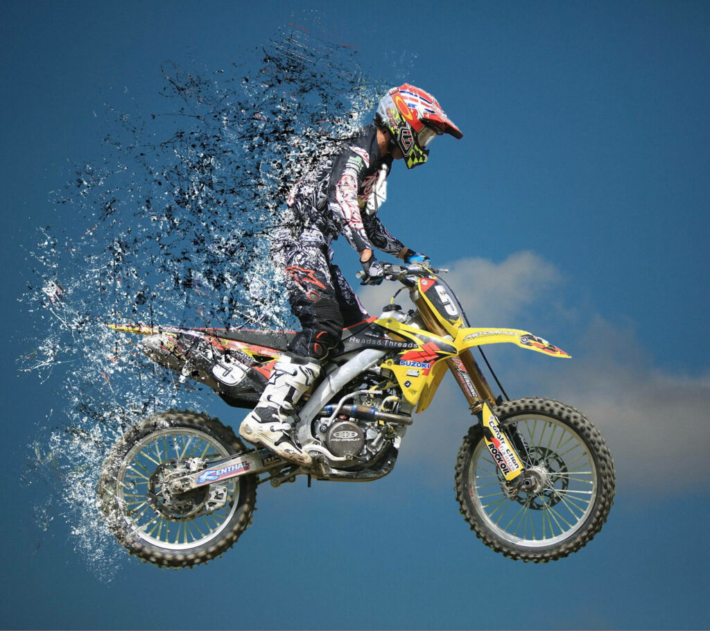 Dynamic Motocross Rider Wallpaper: Yellow Bike & Surreal Sky Action