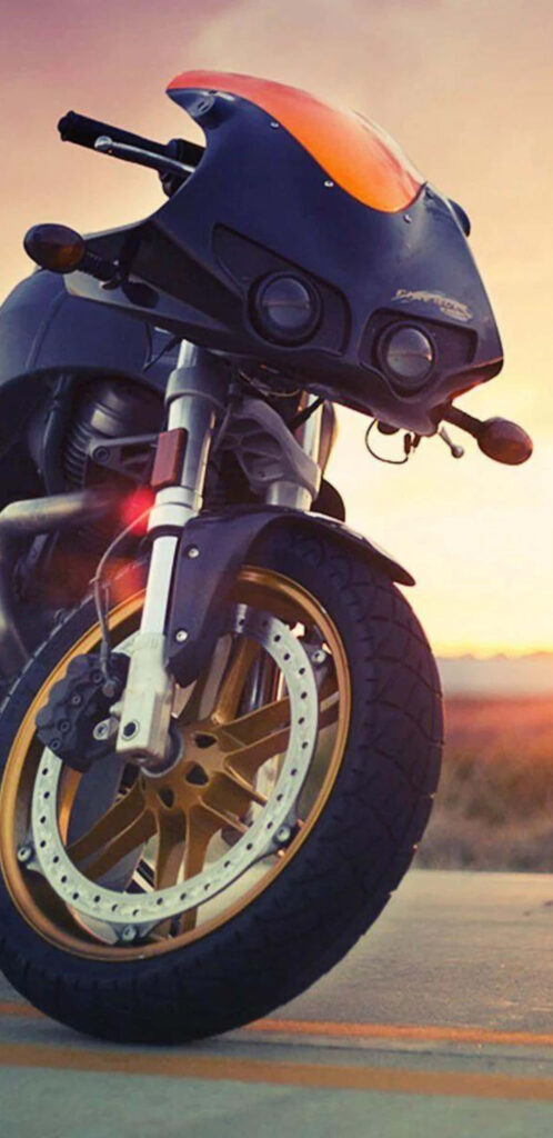 Sleek Motorcycle at Sunset: Bold Design & Golden Rims Wallpaper