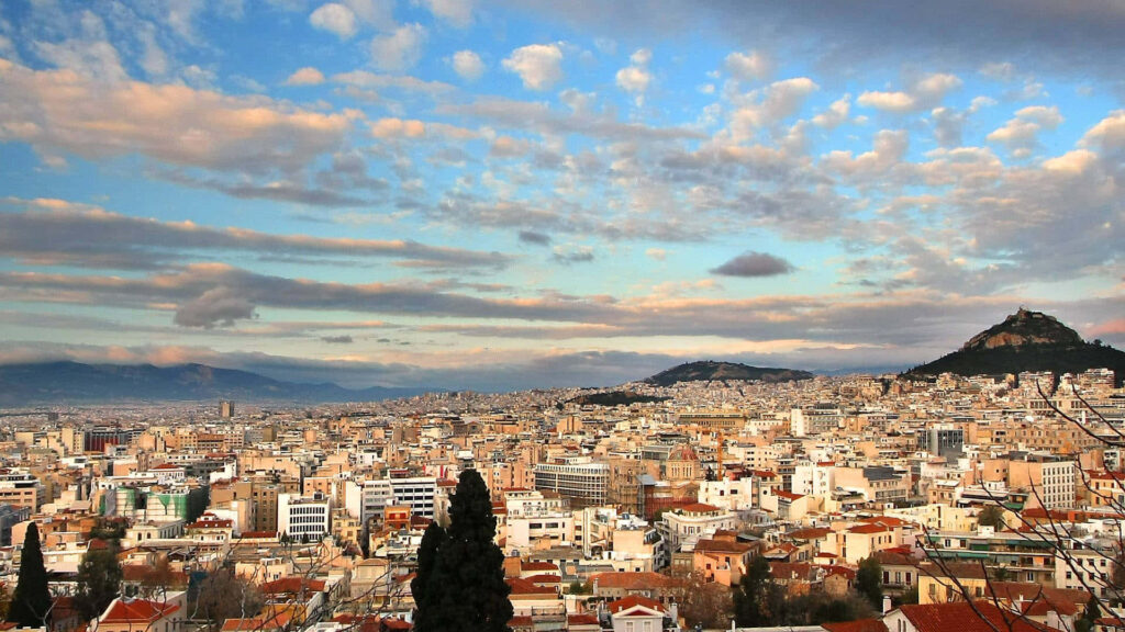 Mount Lycabettus Wallpaper: Stunning Athens Cityscape Under Dramatic Clouds