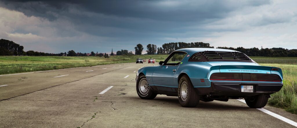 Classic Muscle Car Coupe Wallpaper in Luxurious Scenic Setting
