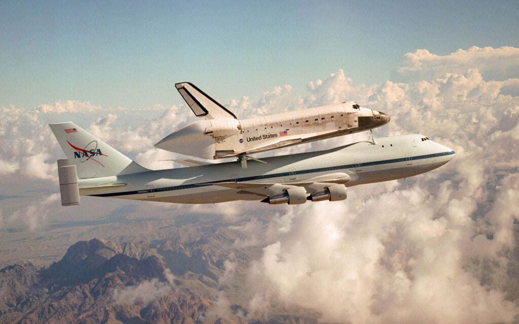 Stunning NASA Wallpaper: Carrier Aircraft & Space Shuttle in Clouds
