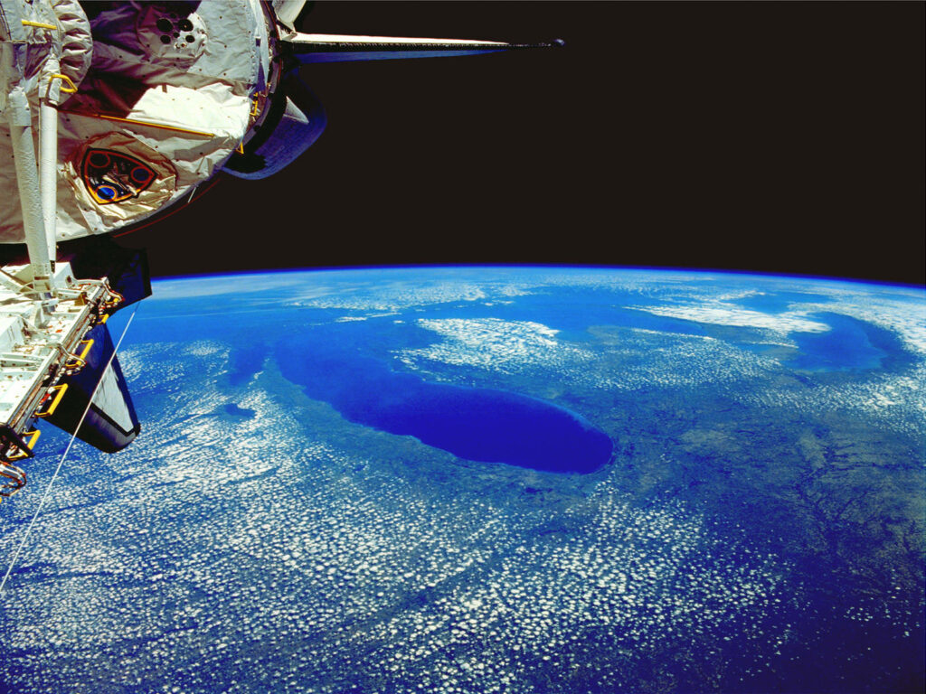 Stunning NASA Wallpaper: Vivid Blue Earth & Spacecraft Background