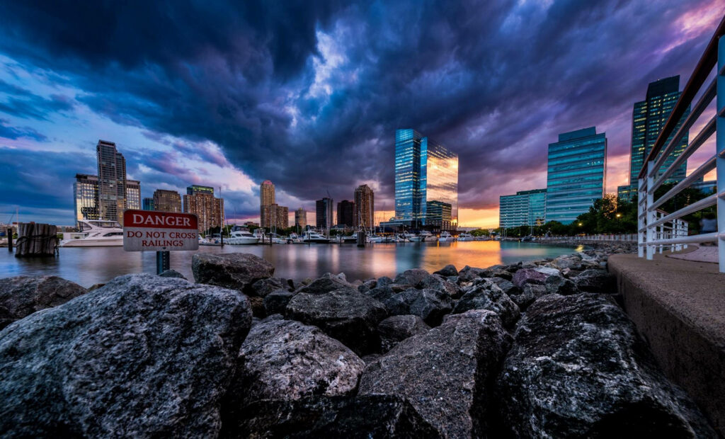 Stunning New Jersey Cityscape Wallpaper: Dramatic Sunset & Cloudy Sky