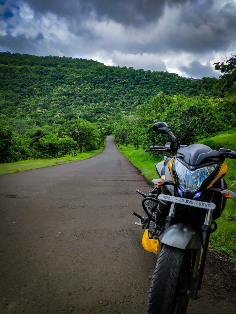 NS 200 Motorcycle: Serene Roadside Scene with Lush Greenery Wallpaper