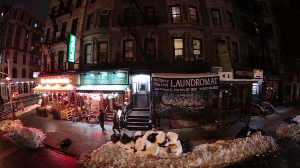 Vibrant NYC Night Street View: Illuminated Storefronts Wallpaper