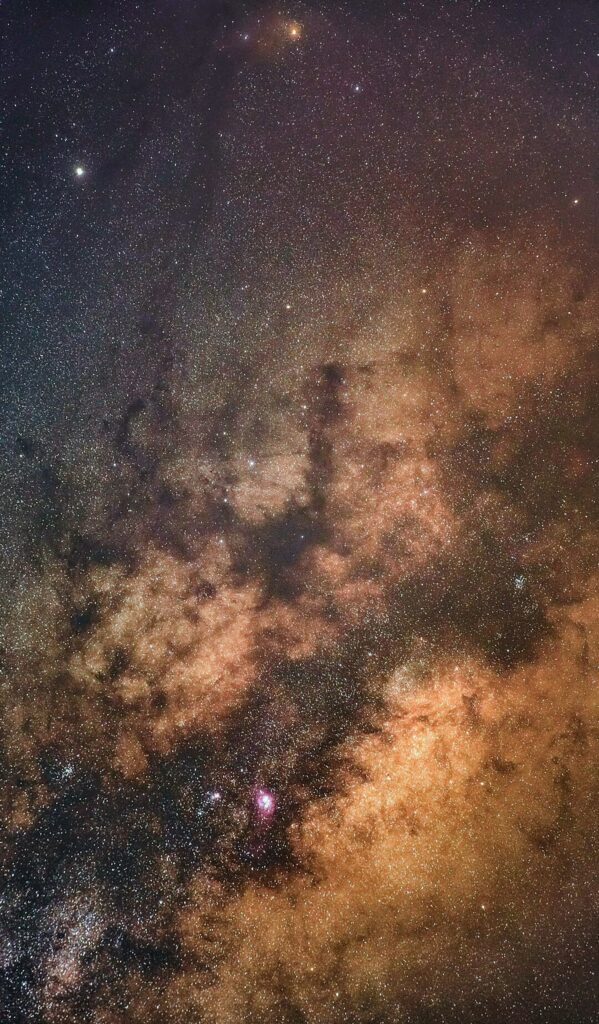 Stunning Nebula Wallpaper: Rich Brown & Gold Cosmic View