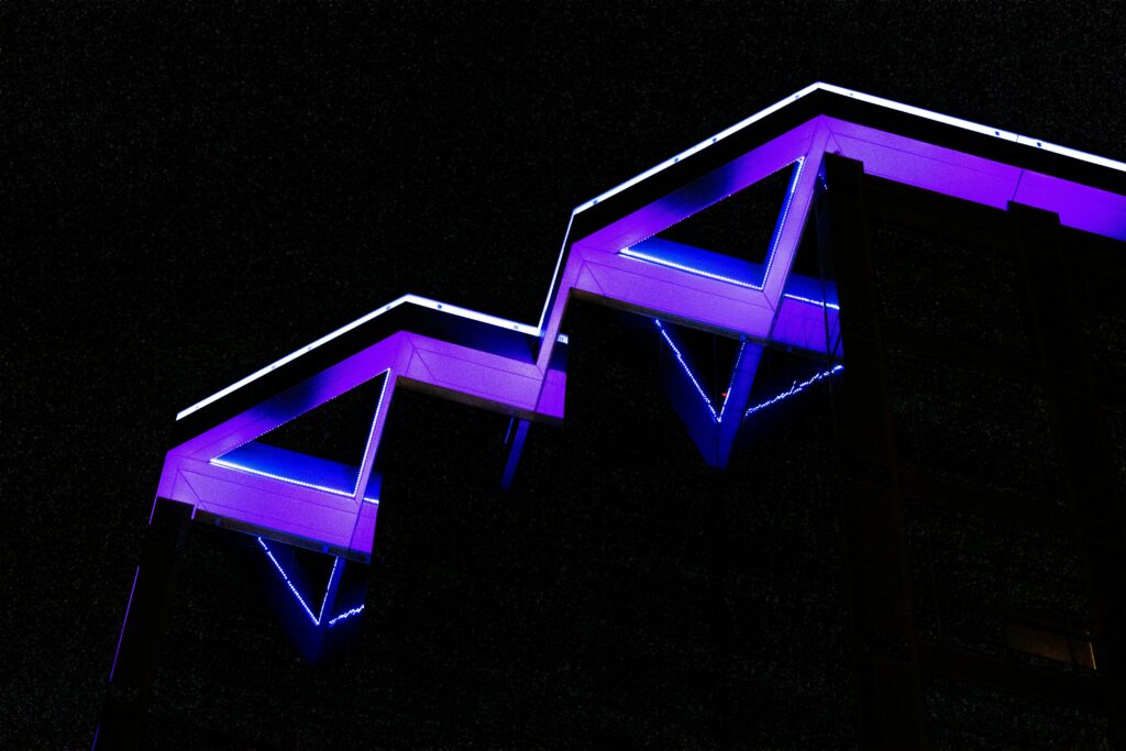 Neon Architectural Wallpaper: Striking Geometric Structure on Black
