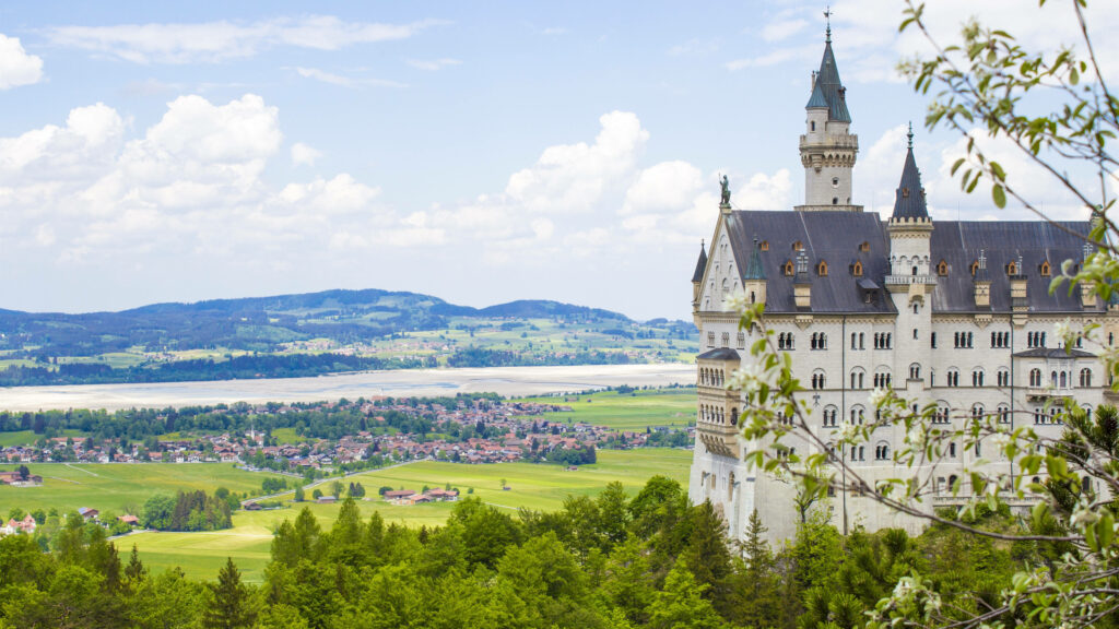 Neuschwanstein Castle Wallpaper: Lush Fields & Scenic Villages