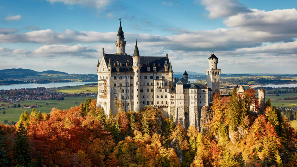 Vibrant Neuschwanstein Castle Wallpaper with Golden Trees & Hills