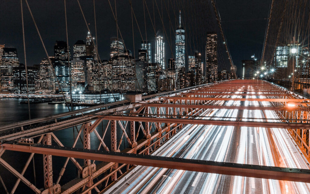 Stunning NYC Bridge Wallpaper: Night View with Skyscrapers & Light Trails