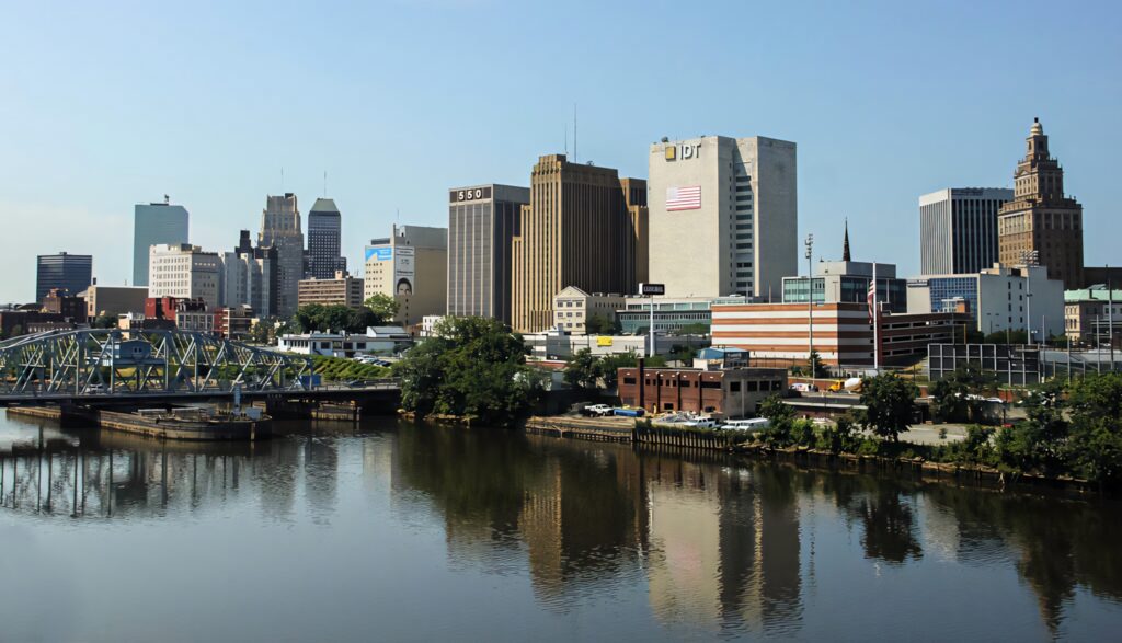 Clear Daytime Newark Skyline Wallpaper: Reflective River & Bright Sky